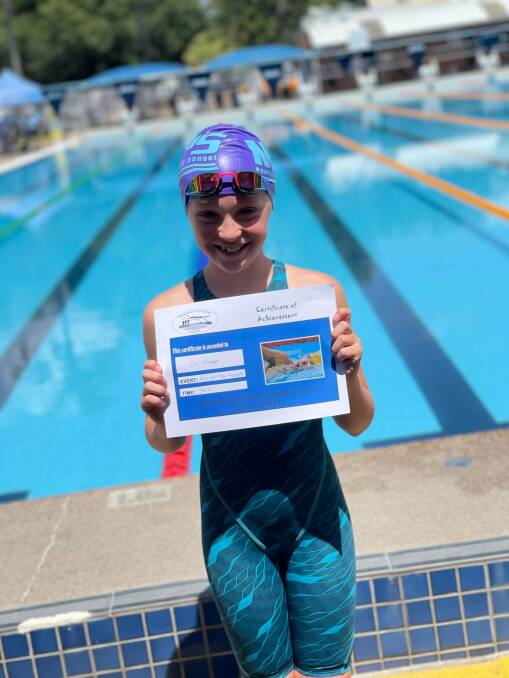 10-year-old Evie Grainger with her achievement certificate at Maitland Aquatic Centre. Picture supplied.