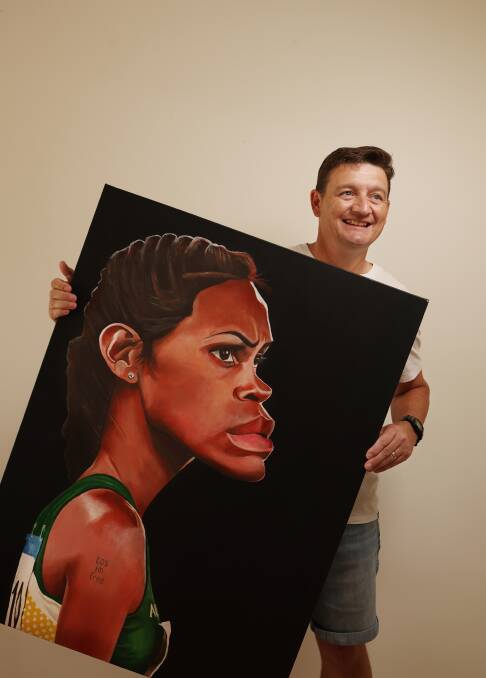 James Brennan at home in Aberglasslyn with one of his past paintings of Cathy Freeman. Picture by Simone De Peak