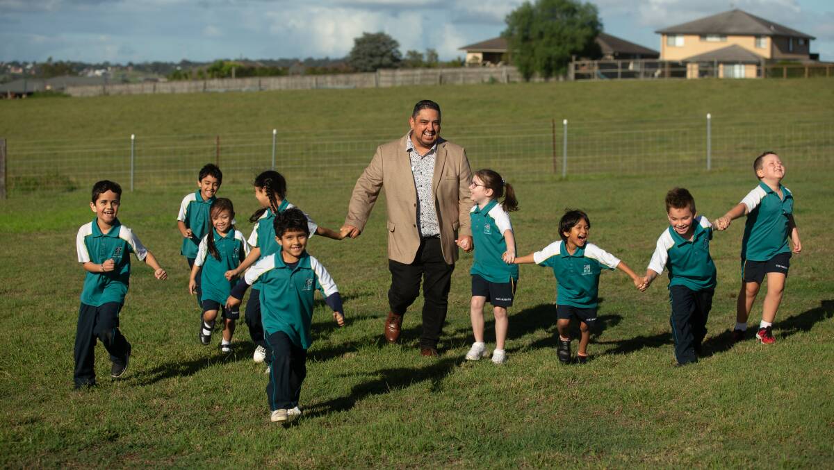 The Heights Learning Community principal John Venegas with the school's nine pupils at Gillieston Heights. Picture by Jonathan Carroll