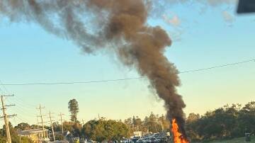 A motorcycle was on fire following a crash on Nelson Bay Road in Fern Bay. Picture supplied