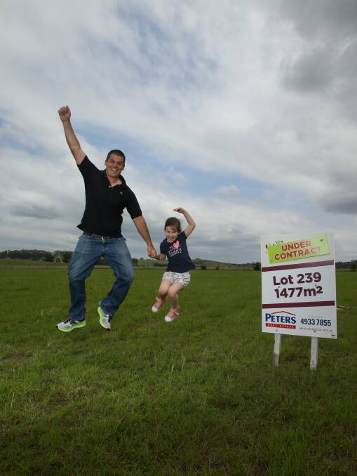 BOUGHT: Home buyer Juri Piirlaid with daughter Amity. Mr Piirlaid slept overnight in his car at St Helenas to ensure he got the lot he wanted. Picture: Jonathon Carroll