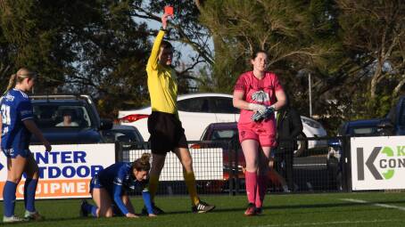 Maitland goal keeper Annabella Thornton is shown a red card after a challenge outside her area on Olympic striker Jemma House. Picture by Michael Hartshorn 
