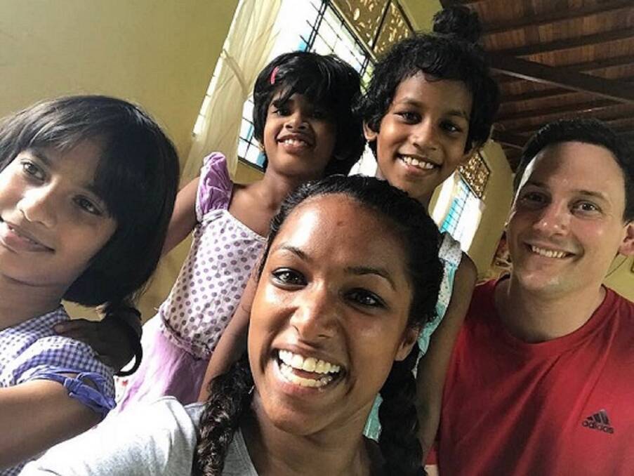 PAYING IT FORWARD: Kacee Rhodes and fiance Phil Jegard pictured with some of the children from the Sri Lankan orphanage Kacee was adopted from.