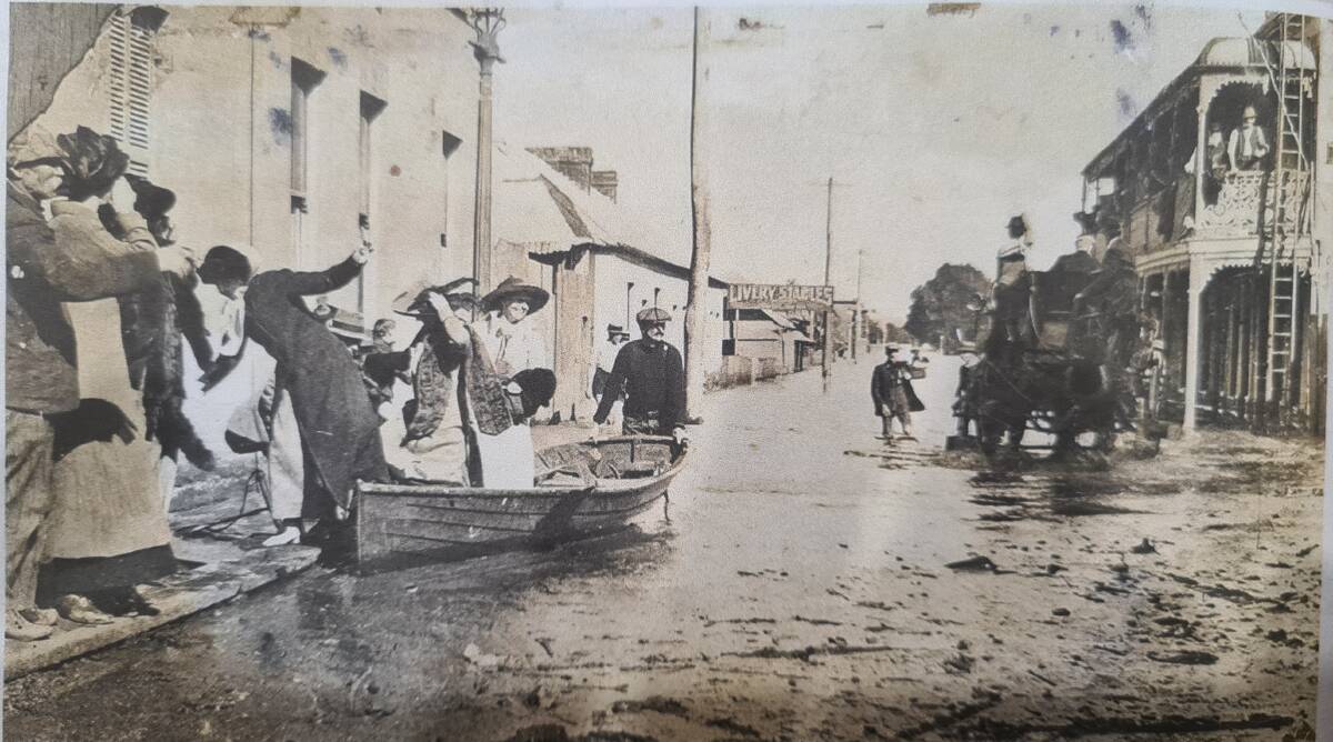 The flood of May 1913 had residents in Devonshire Street, Maitland rowing to their homes. Picture supplied.