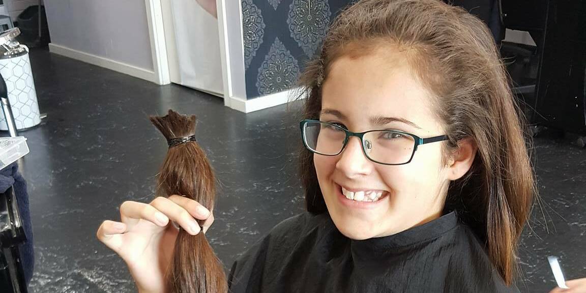 CHOPPED: Hannah Williams pictured with her chopped locks which will be donated to the charity Variety to make wigs for children.
