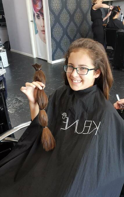 HAIRY: Hannah Williams holds the precious locks she will be donating to Variety to make wigs for kids.