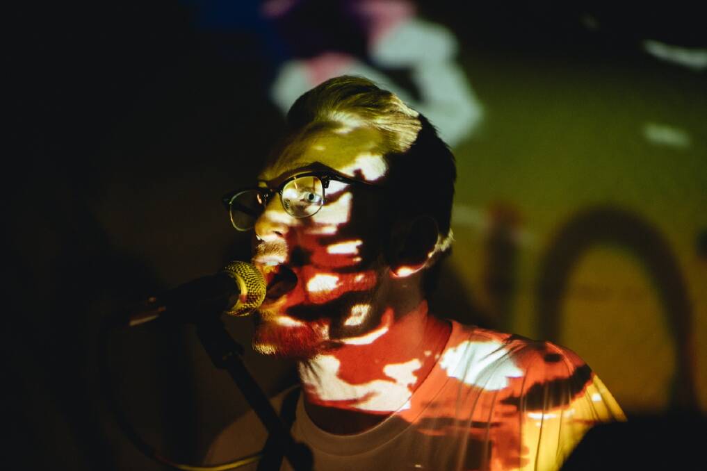 DISTORTED: Joab Eastley of Kurri Kurri distortion-dance rock band Raave Tapes illuminated by a projector at a Newcastle show. Picture: PERRY DUFFIN