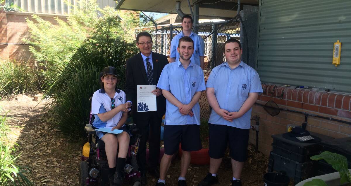 GREEN GRANT: Parliamentary Secretary for the Hunter, Scot MacDonald with students from Maitland Grossmann High School, which received a $3500 grant. Picture: Supplied