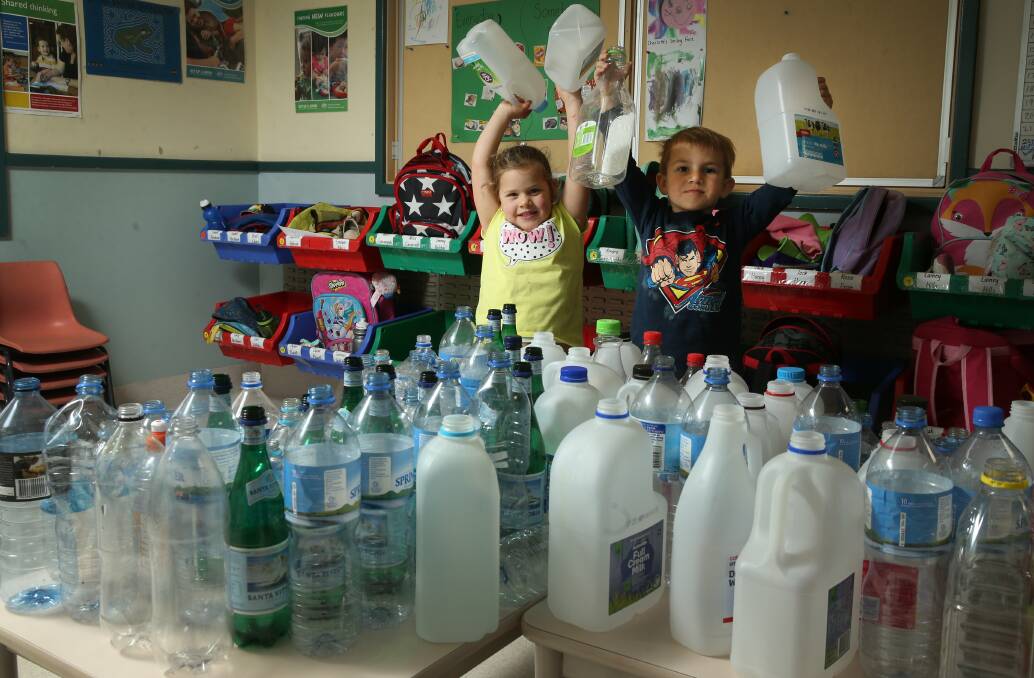 PLANETEERS: Millie 4yrs and Jimmy 4yrs with some bottles they are recycling after reading a book called, 'Look After Your Planet". Picture: Marina Neil