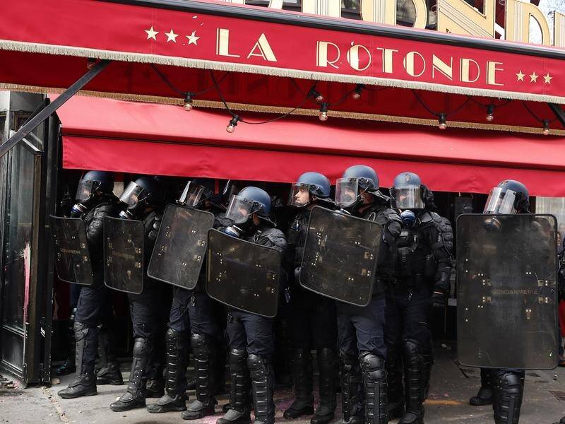 French riot Police stand by La Rotonde restaurant during clashes with protesters in Paris. (EPA PHOTO)