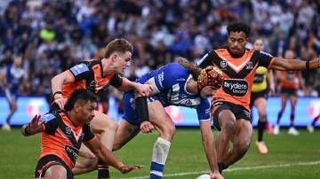 Josh Curran scores for the Bulldogs in their 22-14 win over Wests Tigers. (James Gourley/AAP PHOTOS)