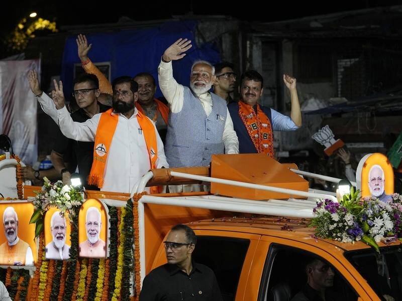 Indian Prime Minister Narendra Modi waves to supporters during a rally in Mumbai. (AP PHOTO)